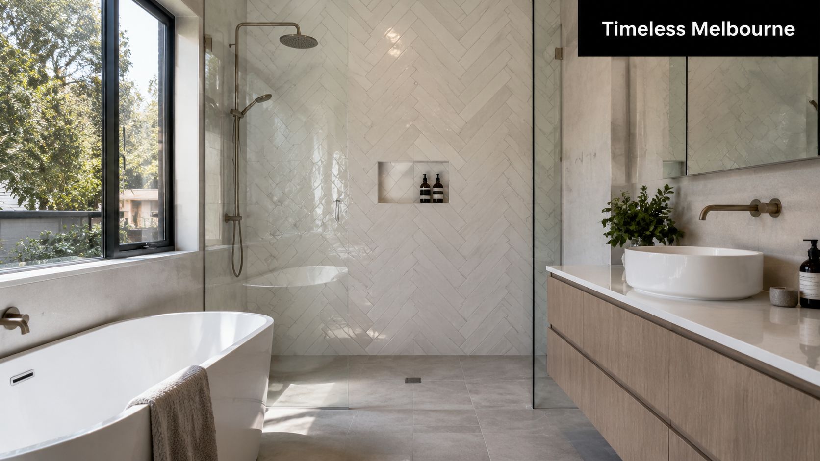 A modern, bright bathroom featuring a large herringbone tile pattern wall, freestanding bathtub, and floating vanity.
